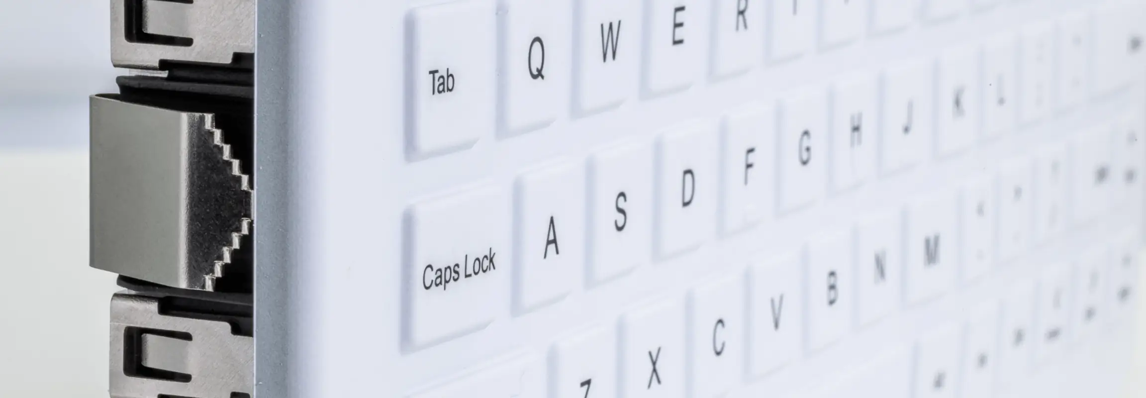 Close-up angled view of white CliniKey Panel-Mount Medical Keyboard keys