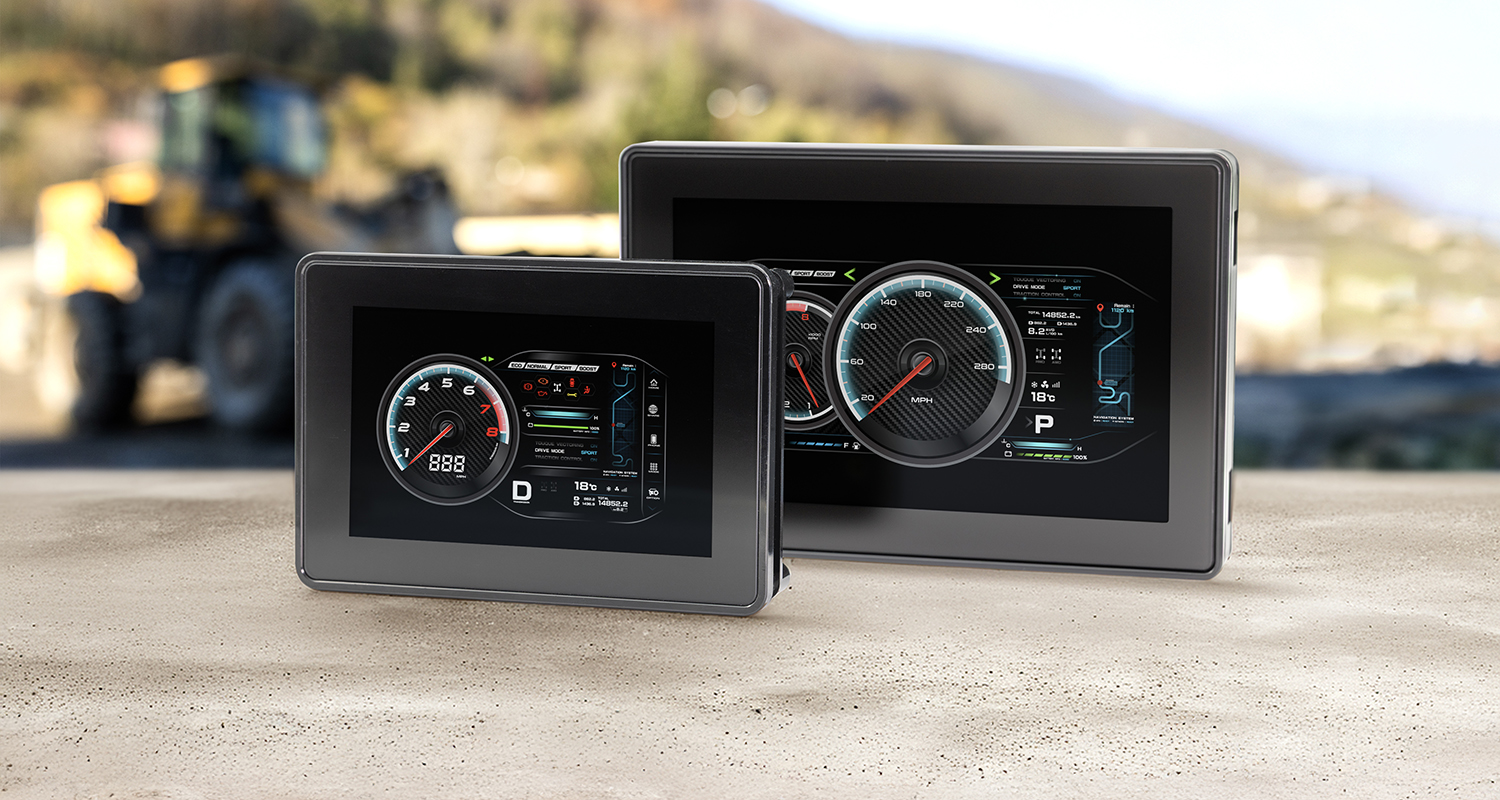Grayhill's 3D50 5-inch and 3D70 7-inch CAN Bus Displays sitting on a concrete surface in front of an outdoor construction environment.